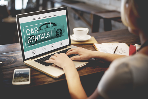 person searching for car rental online
