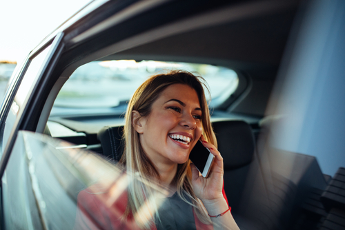 woman talking on phone in rental car