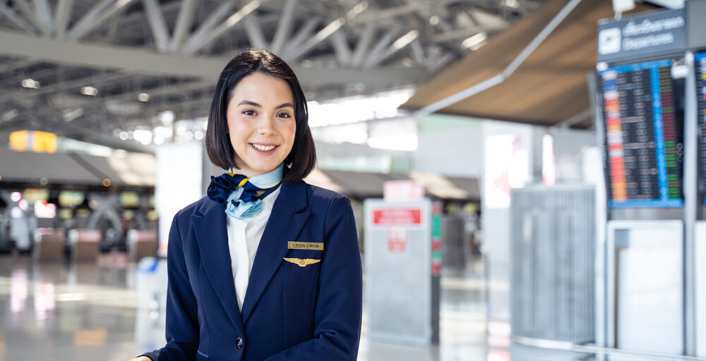 Flight attendant smiling in airport