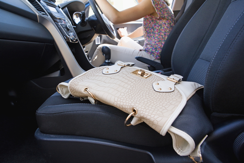 purse sitting in a rental car