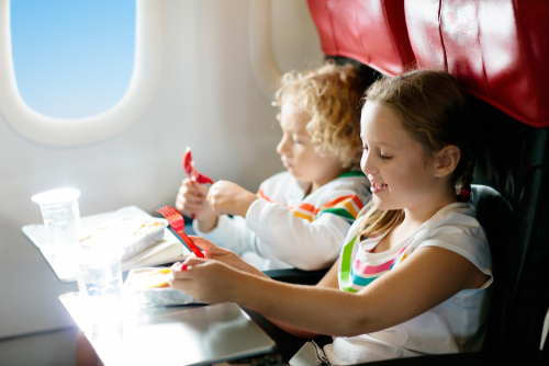 child eating on airplane