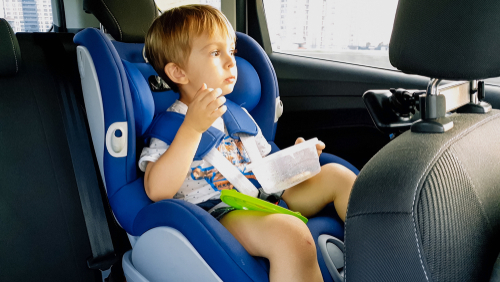 child eating in car