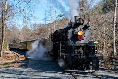 A steam powered locomotive on the train tracks in the Great Smoky Mountains