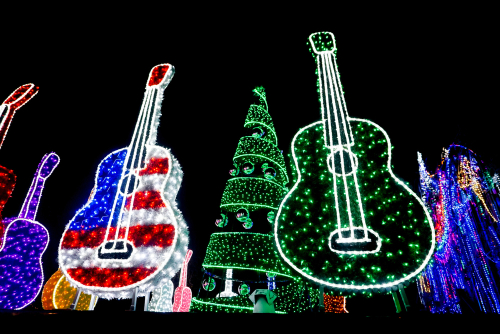 Bright Red, Red White and Blue and Purple and Green Guitars and Holiday Tree with Ornaments lit up with Lights at Mozart's Coffee on Lake Travis in Austin, Texas