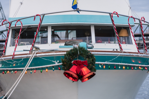 Boat Docked at Marina Adorned with Christmas Holiday Lights, Candy Canes, Wreath and Bells