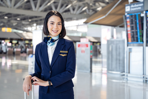 Flight attendant smiling in airport