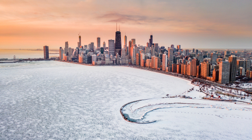 Aerial view of a frozen-over Lake Michigan and the Chicago skyline.