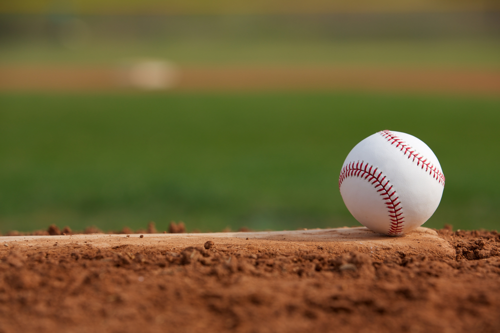Close-up of a baseball sitting on a pitching mound.