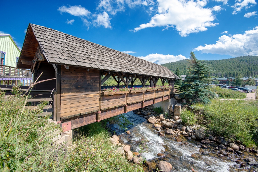 A wooden covered bridge crossing over Middle Boulder Creek in Nederland Colorado