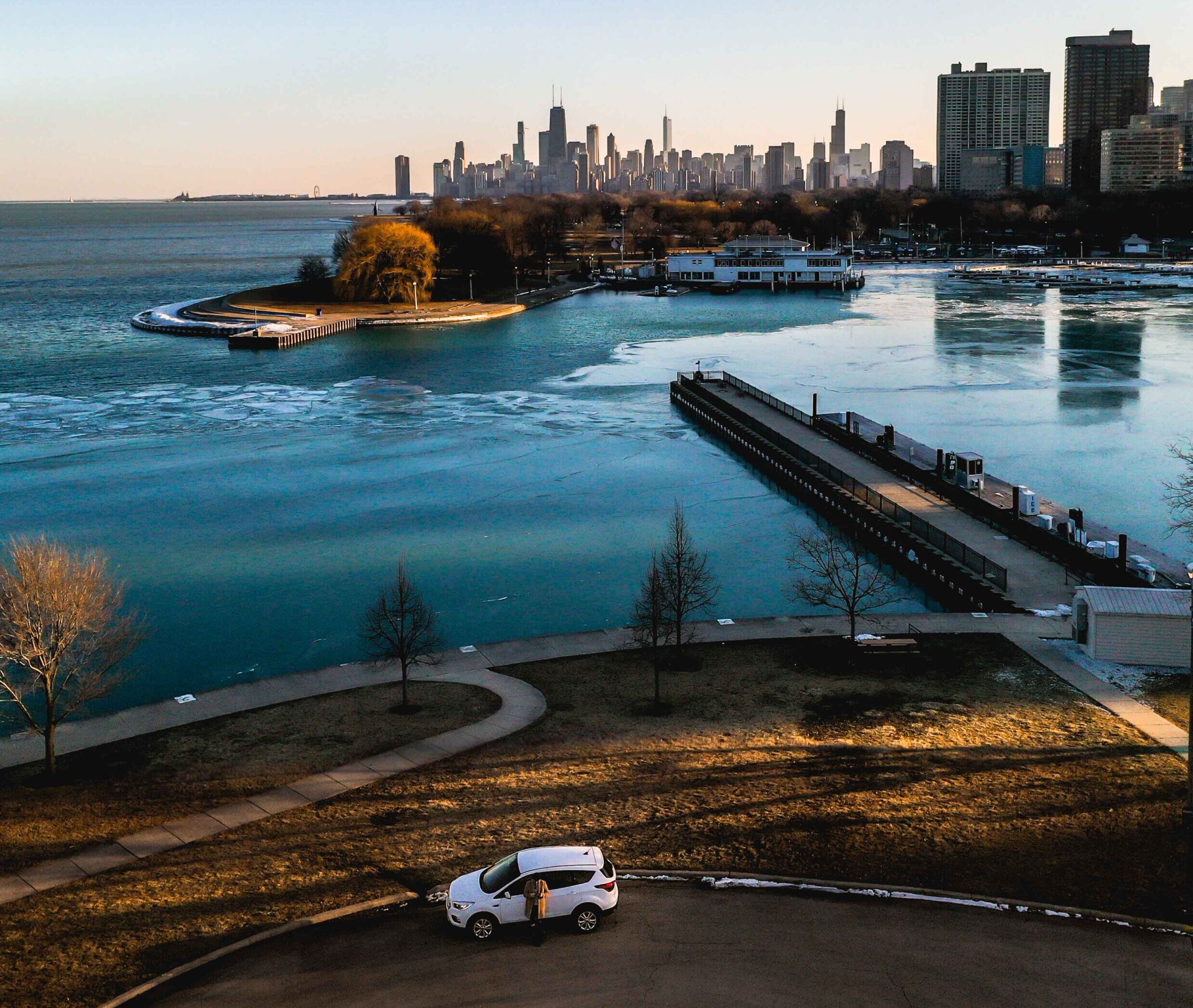 Aerial image of a parked car with Lake Michigan and the Chicago skyline in the background.