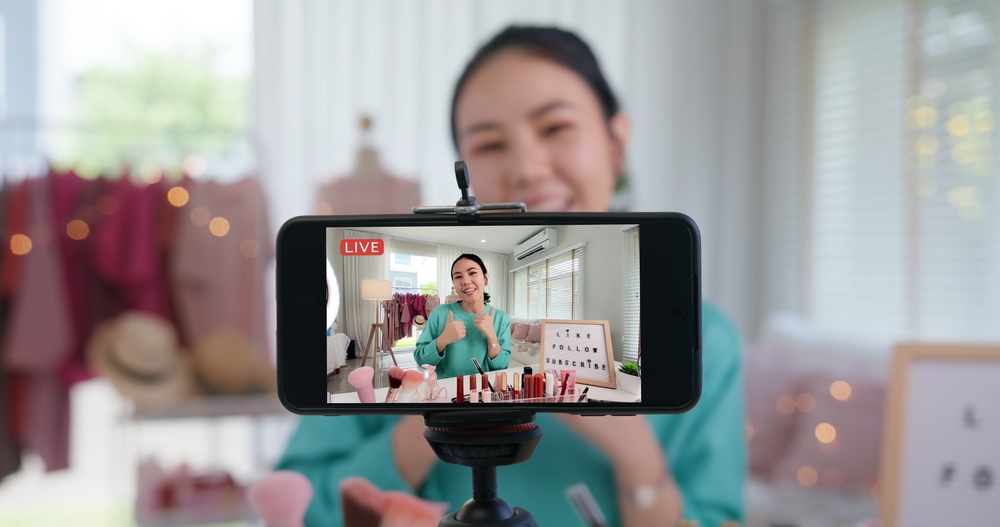 Asia woman micro influencer record live viral video camera at home studio. 