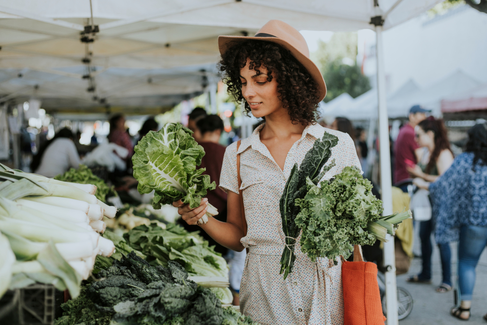 Woman buying kale at a farmers market